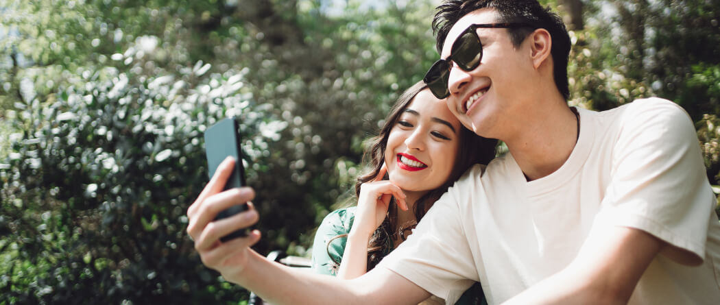 Two young people taking a selfie with a smartphone